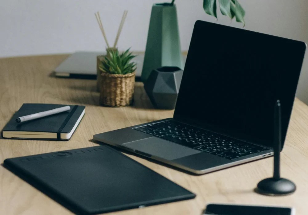 Black Laptop Computer On Brown Wooden Table