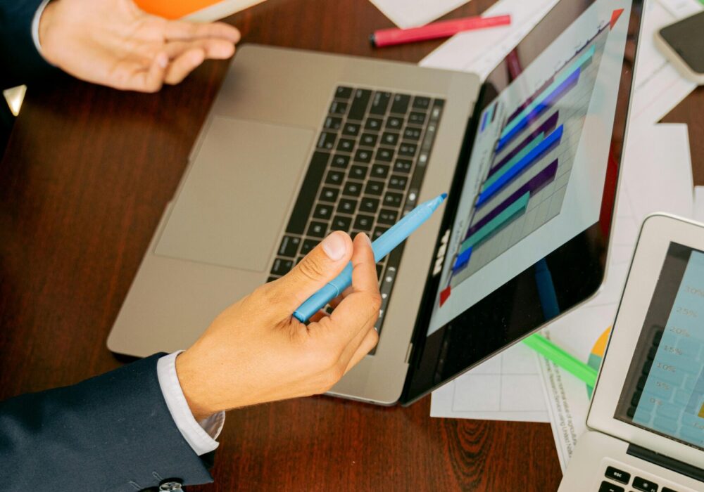 Free A Person in Black Suit Holding a Pen Stock Photo