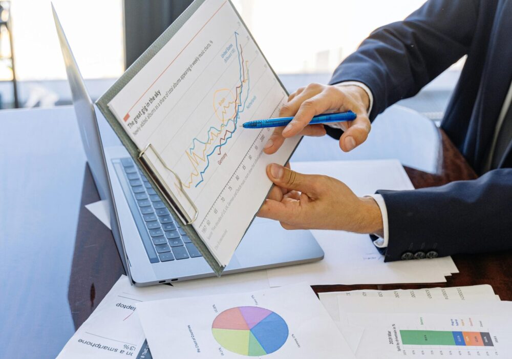 Free Business professionals discussing financial graphs and charts in an office setting. Stock Photo