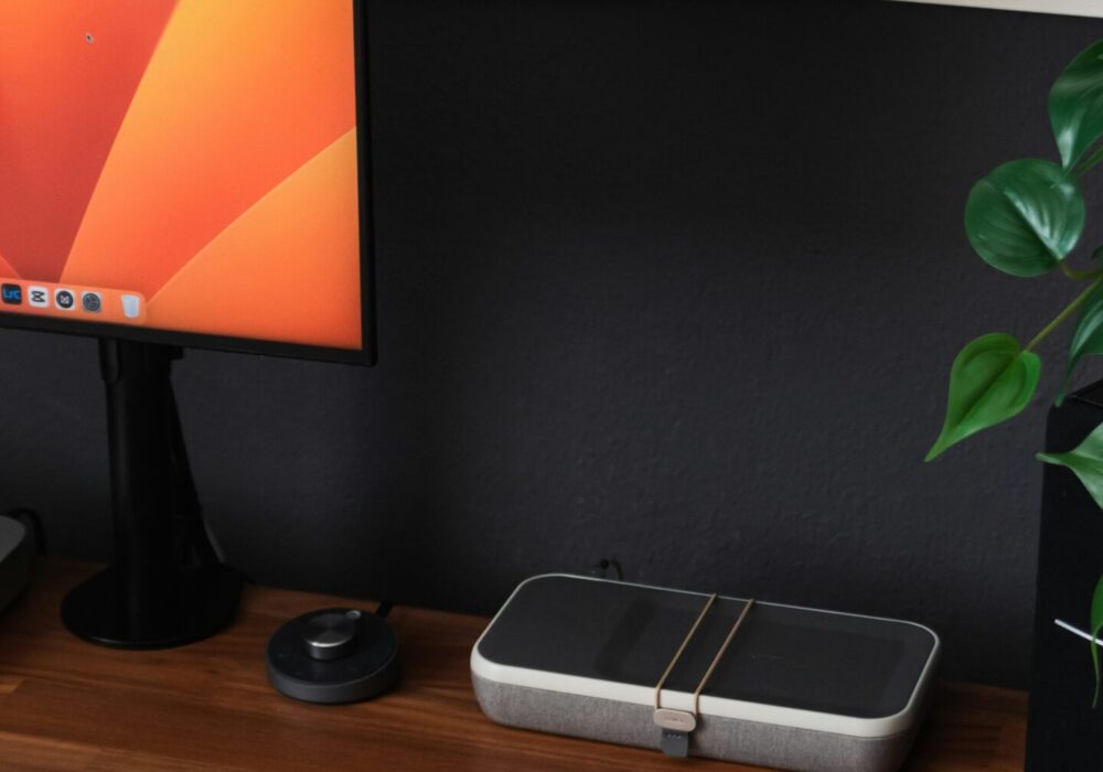 a desk with a laptop, keyboard, mouse and a monitor