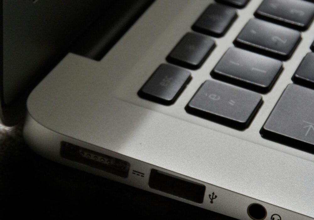 Free Detailed view of a silver laptop showing keyboard and multiple ports. Stock Photo